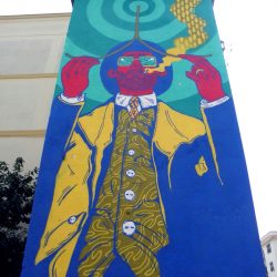 Il graffito di El Rughi raffigurante un rabdomante sulla cabina Enel di Martina Franca